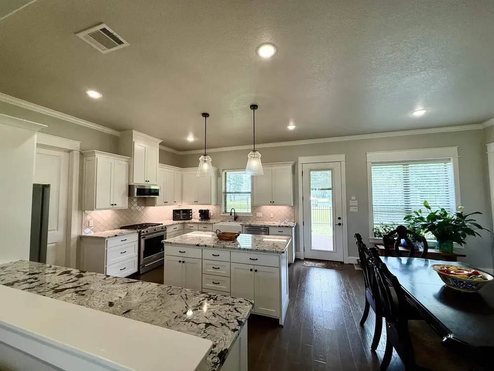 Kitchen with granite counters open to the living and dining area at 644 An County Road 3009 on Lake Palestine in Frankston TX