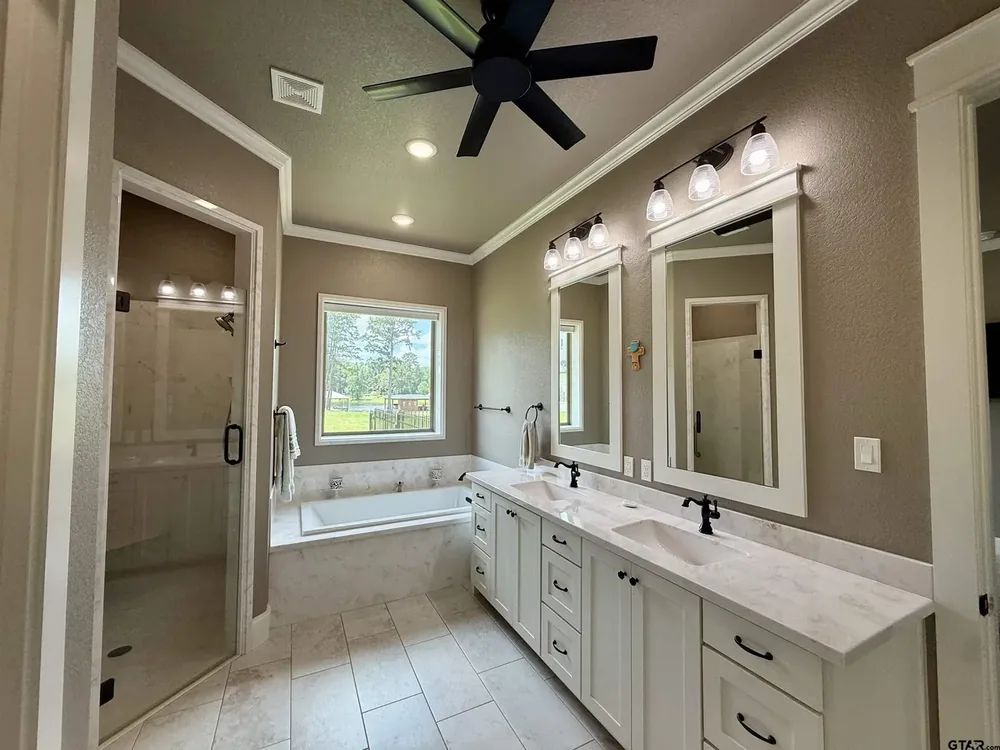Primary bathroom with soaking tub and separate walk-in shower at 644 An County Road 3009 on Lake Palestine in Frankston TX