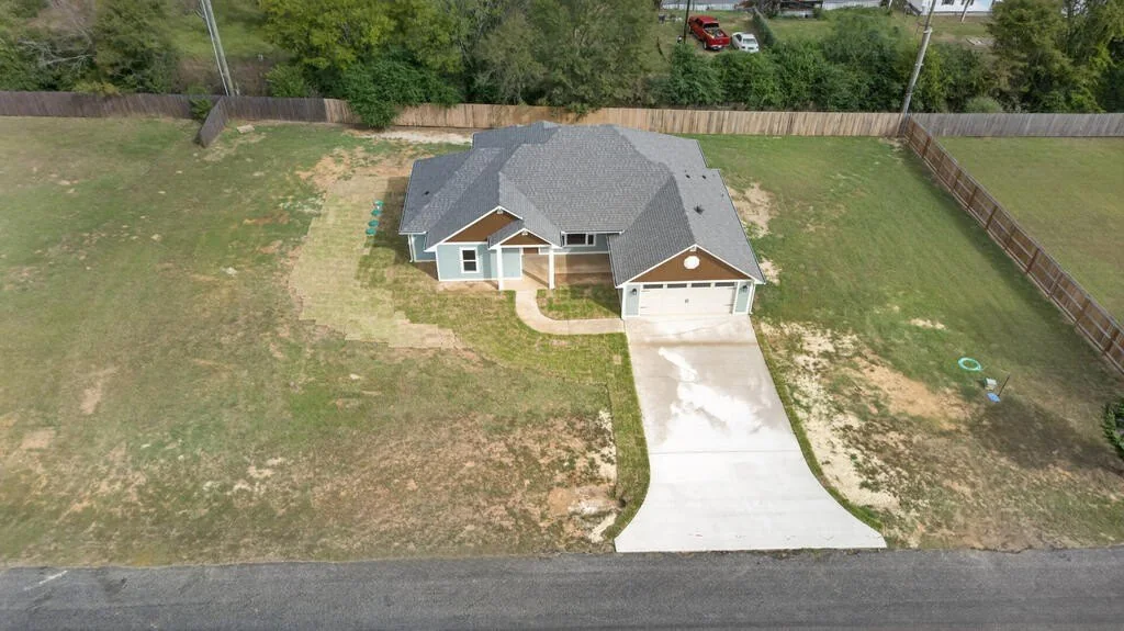 Aerial view of the house, driveway and roughly half-acre lot at 281 ACR 308.