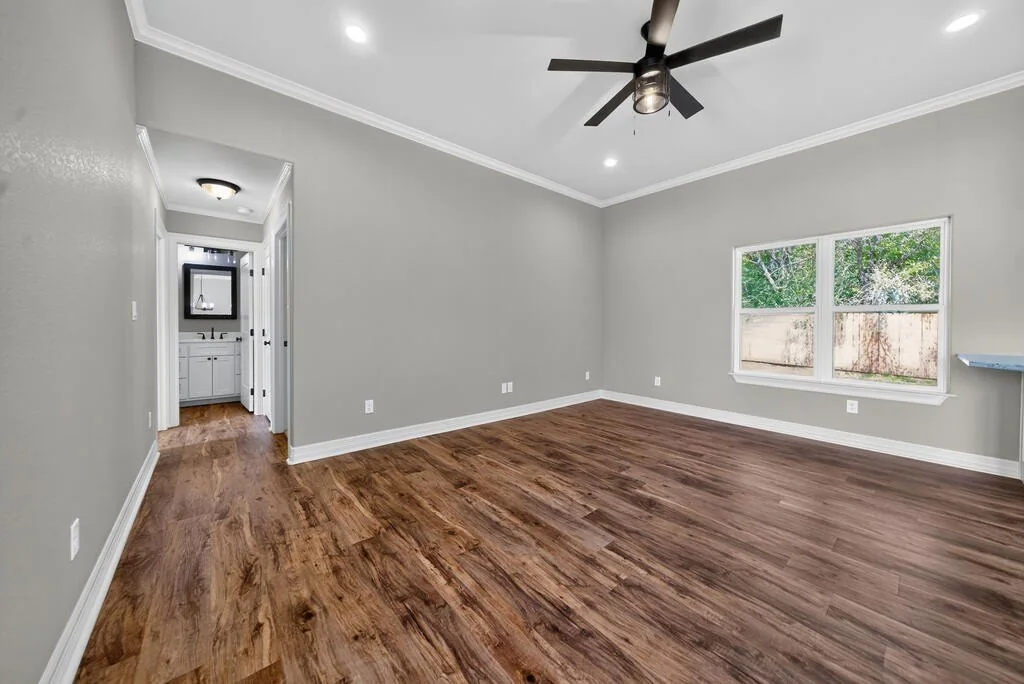 Corner of the living area with a hallway leading to a bathroom at 281 ACR 308.