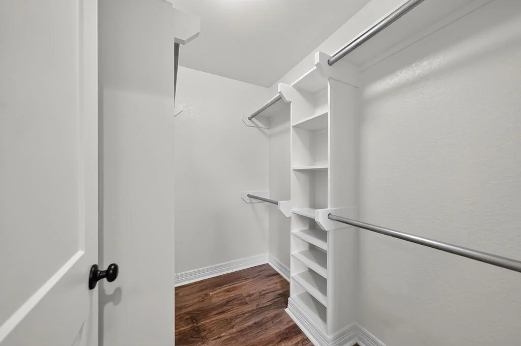Walk-in closet with built-in shelving and hanging rods at 281 ACR 308.