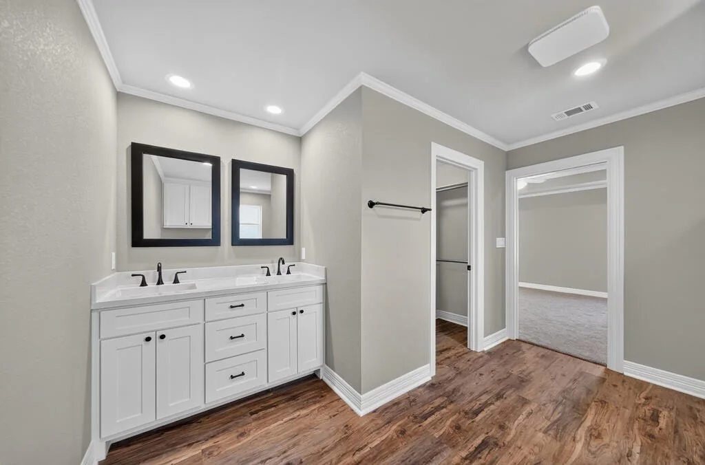 Double vanity with a view into the walk-in closet and bedroom at 281 ACR 308.