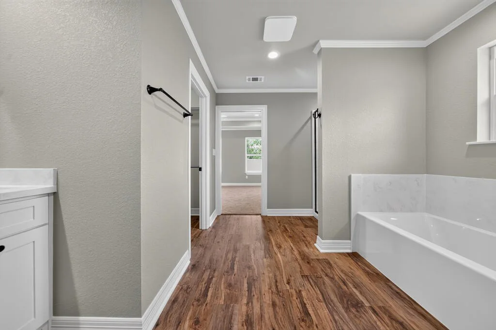 Bathroom with a tub, looking out through the doorway at 281 ACR 308.