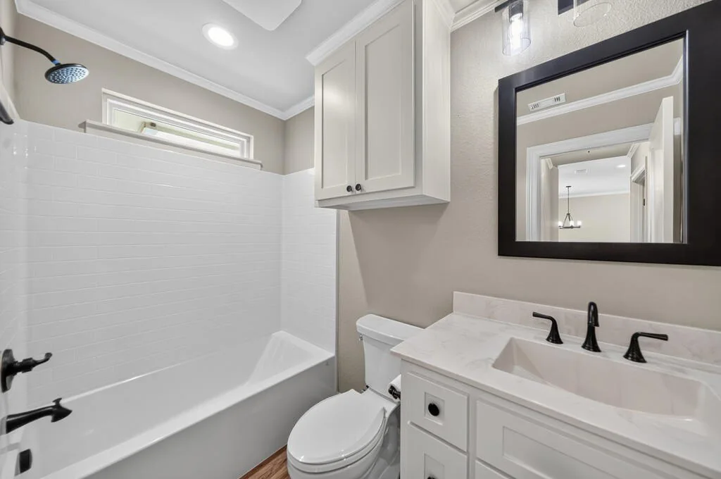 Hall bathroom with a tub and shower, subway tile surround and a single vanity at 281 ACR 308.