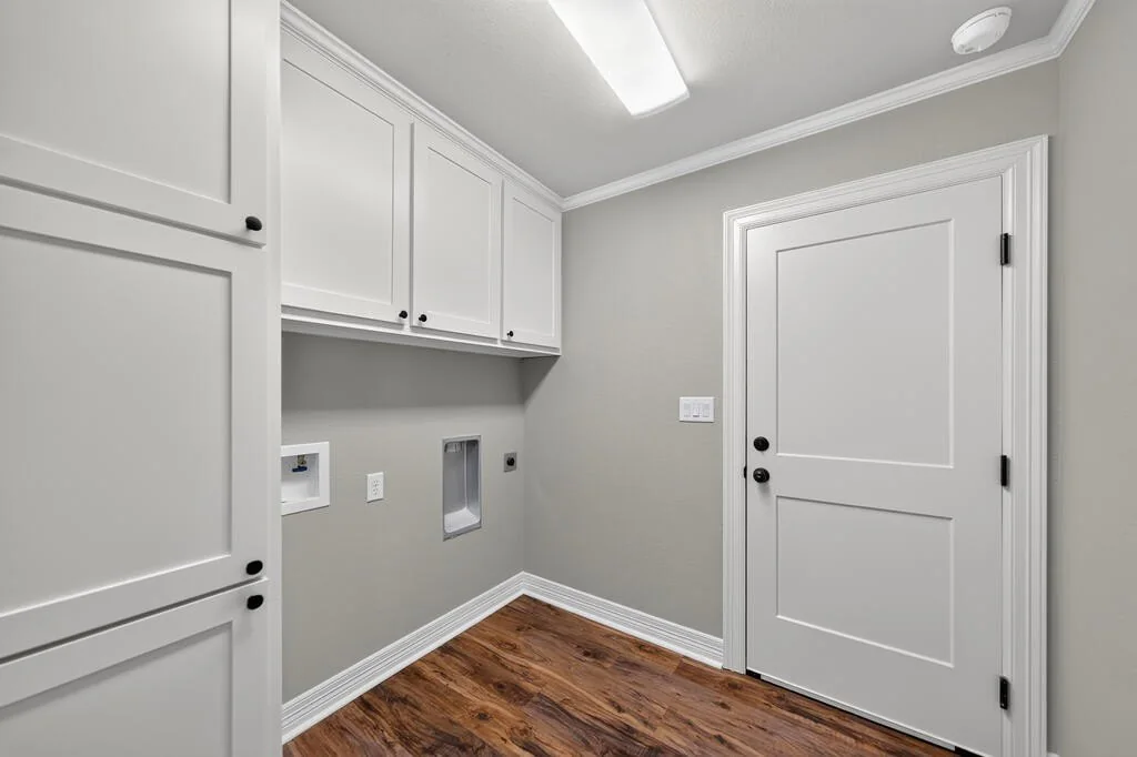 Utility room with washer and dryer connections and upper cabinets at 281 ACR 308.