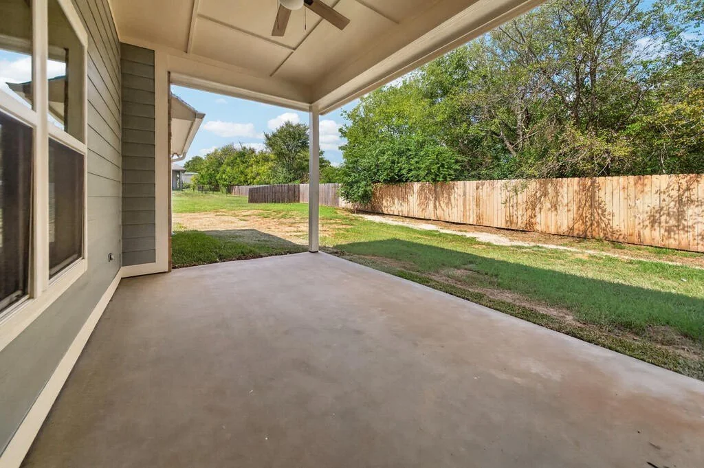 Covered back porch looking out to the backyard at 281 ACR 308.