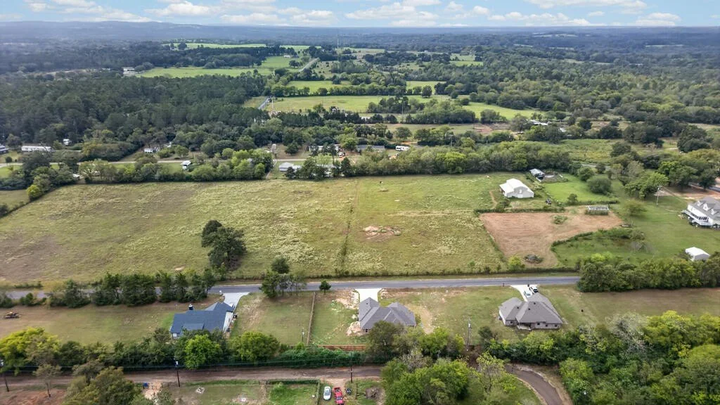 Aerial view over pastures and the county road near 281 ACR 308.