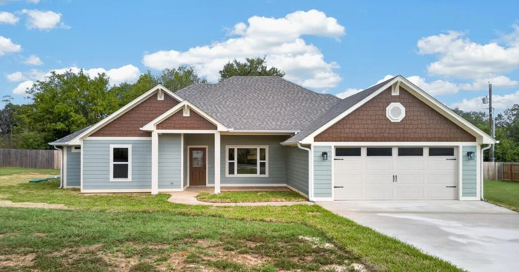 Front of 281 ACR 308 with the covered entry and attached garage.