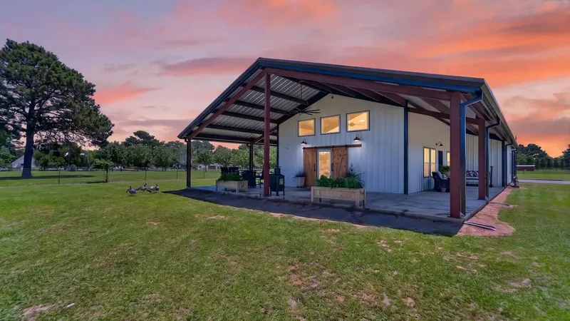 2024 barndominium at 21230 County Road 4202 in Chandler TX, across from Brown's Landing at Lake Palestine, at twilight.