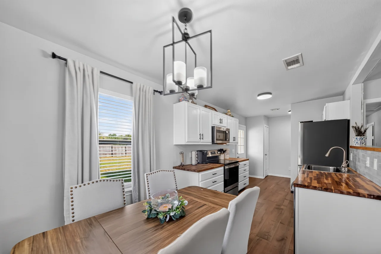 Dining area with a lantern light fixture next to the kitchen at 1054 Caroline Ln in Shadybrook, a gated Lake Palestine community in Bullard, TX.