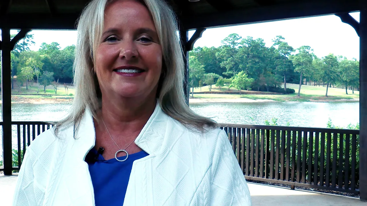Charlene Hall speaking to camera under a lakeside gazebo on Lake Palestine, East Texas