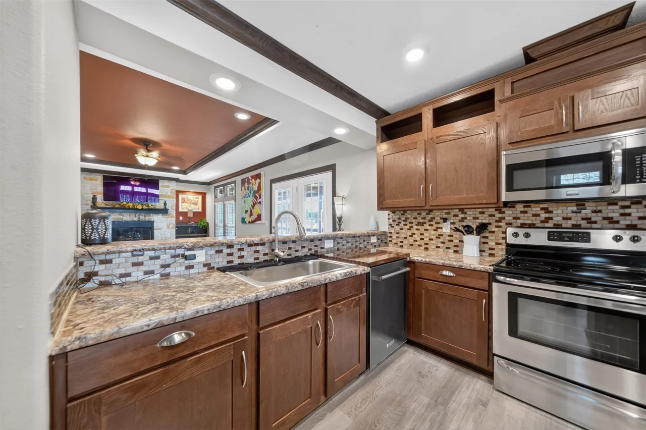 Kitchen counter and range looking toward the living room fireplace at 21138 County Road 4202 in Chandler, TX, across from Brown's Landing on Lake Palestine.