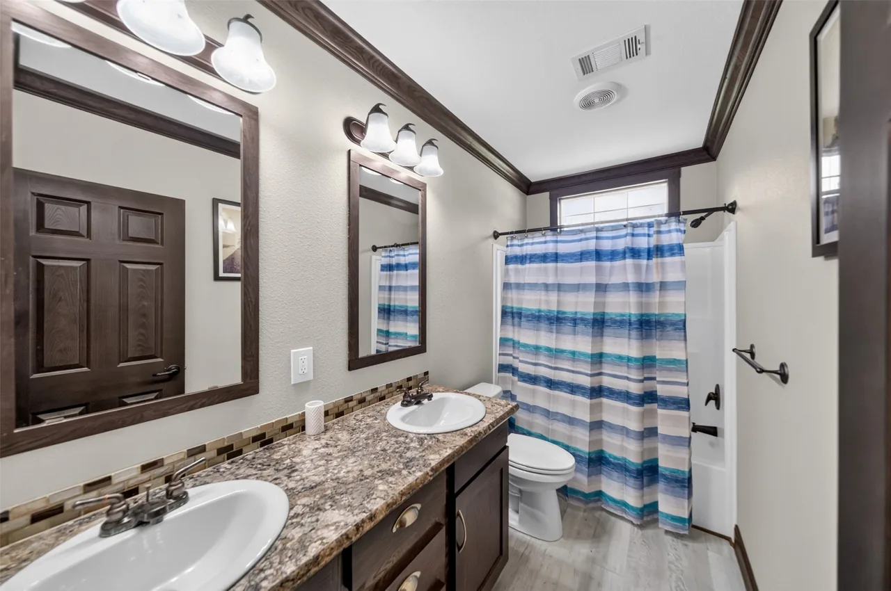 Hall bathroom vanity and tub with shower from a second angle at 21138 County Road 4202 in Chandler, TX, across from Brown's Landing on Lake Palestine.