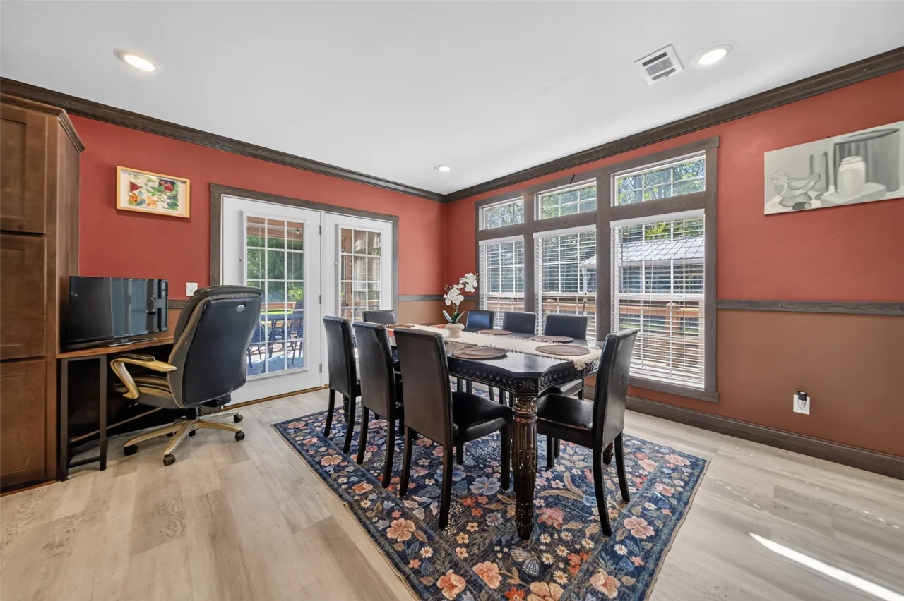 Dining area by the windows with French doors and a desk nook at 21138 County Road 4202 in Chandler, TX, across from Brown's Landing on Lake Palestine.