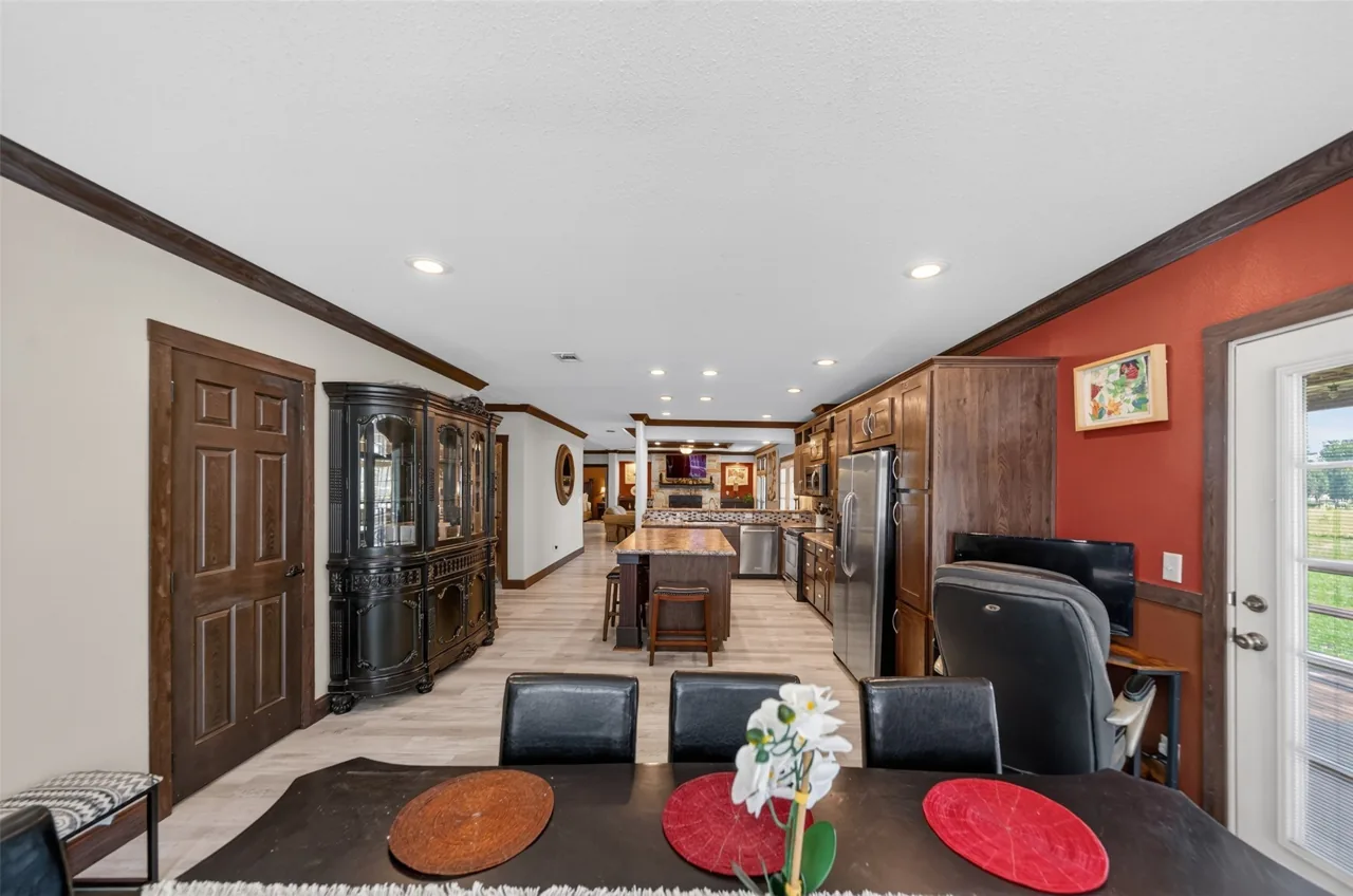 View from the dining table through the open floor plan to the kitchen at 21138 County Road 4202 in Chandler, TX, across from Brown's Landing on Lake Palestine.