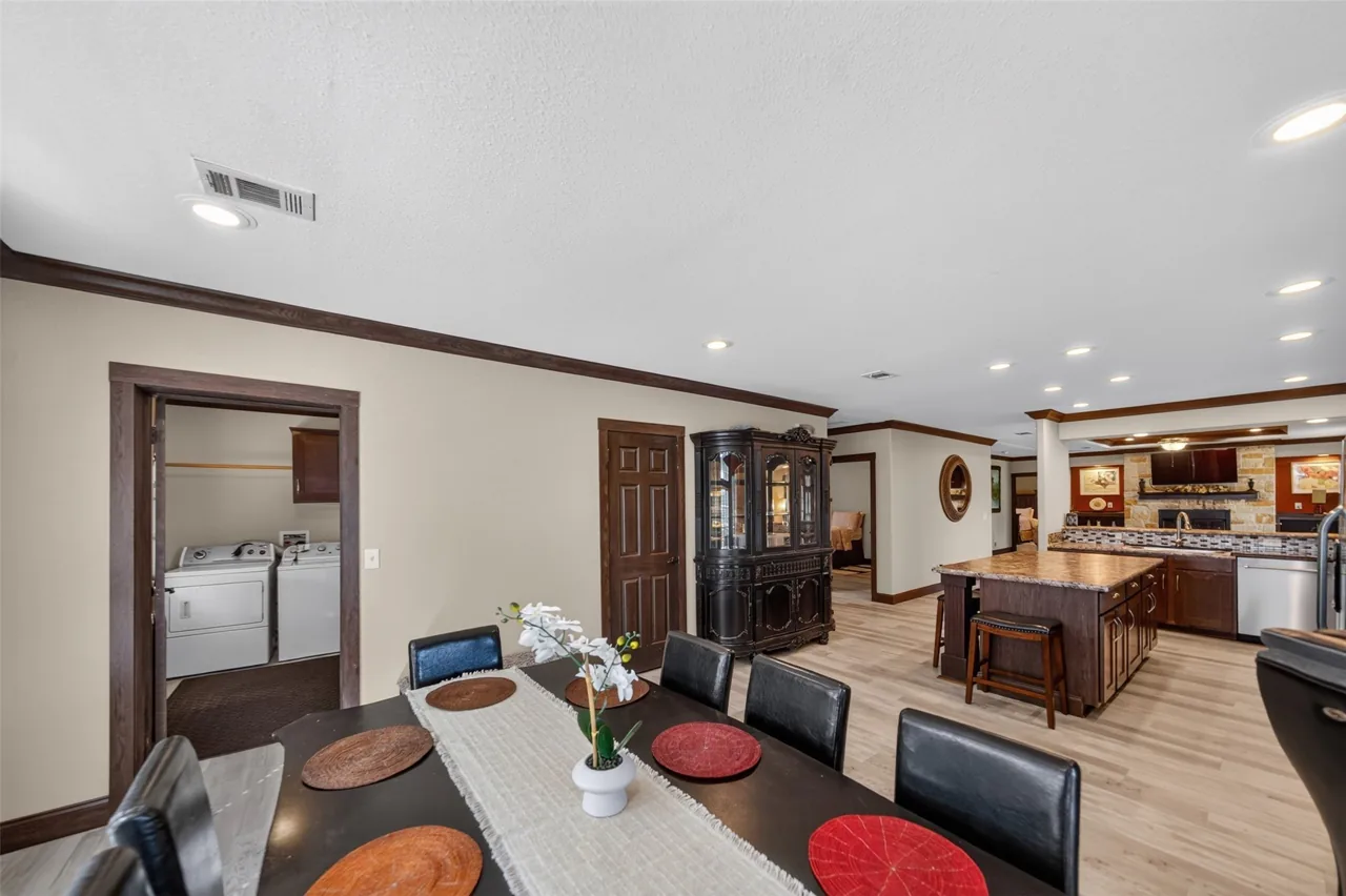 Dining area and kitchen island in the open floor plan at 21138 County Road 4202 in Chandler, TX, across from Brown's Landing on Lake Palestine.