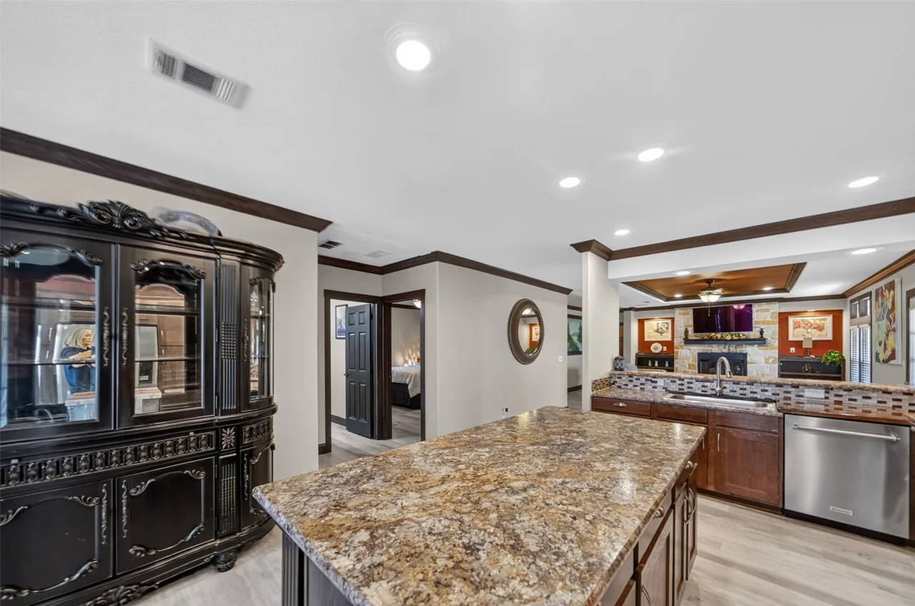 Kitchen island with a china cabinet and hallway beyond at 21138 County Road 4202 in Chandler, TX, across from Brown's Landing on Lake Palestine.