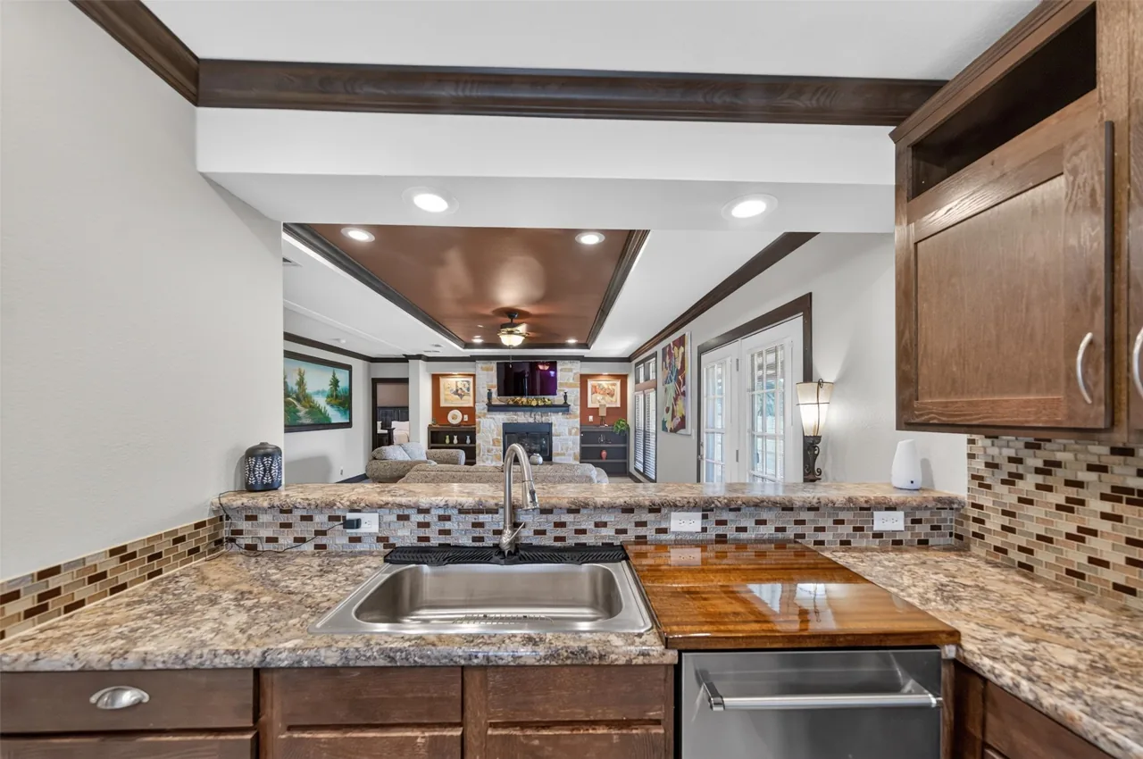 Kitchen sink with a butcher block insert, looking into the living room at 21138 County Road 4202 in Chandler, TX, across from Brown's Landing on Lake Palestine.