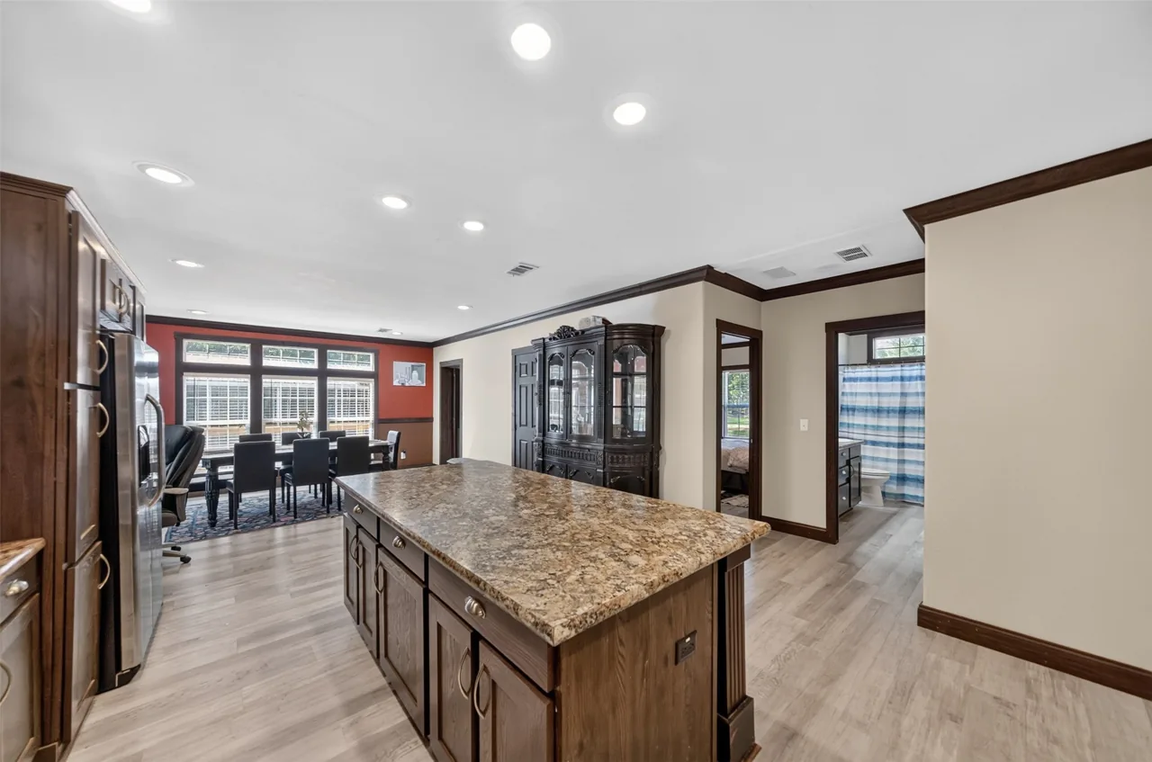Kitchen island with the dining area and hallway at 21138 County Road 4202 in Chandler, TX, across from Brown's Landing on Lake Palestine.