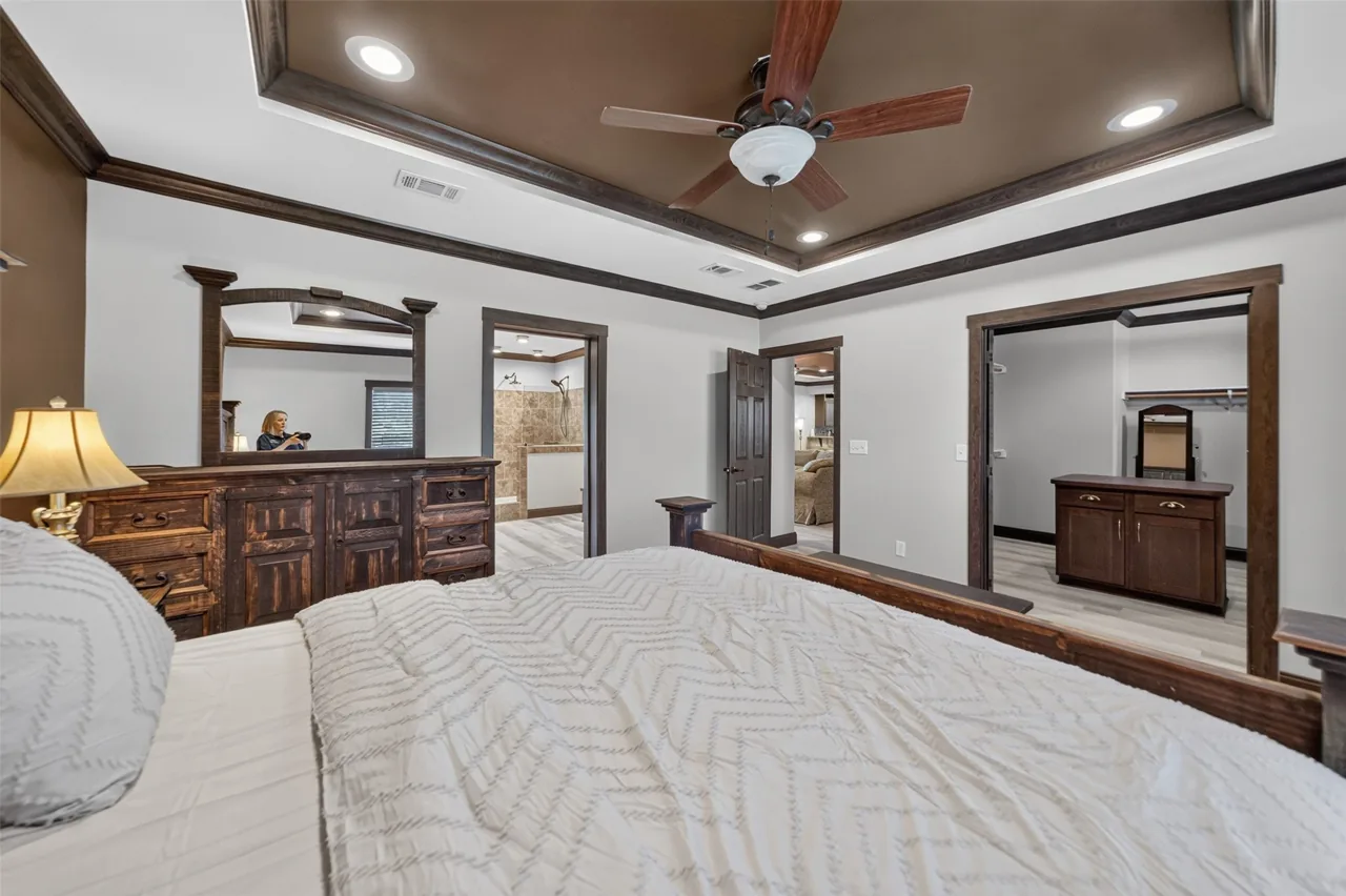 Primary bedroom looking toward the dresser and the primary bath at 21138 County Road 4202 in Chandler, TX, across from Brown's Landing on Lake Palestine.