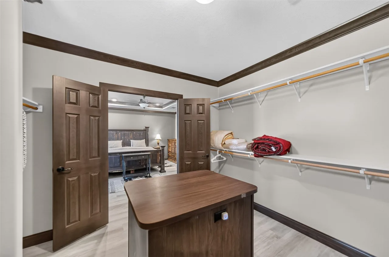 Primary walk-in closet looking back into the primary bedroom at 21138 County Road 4202 in Chandler, TX, across from Brown's Landing on Lake Palestine.