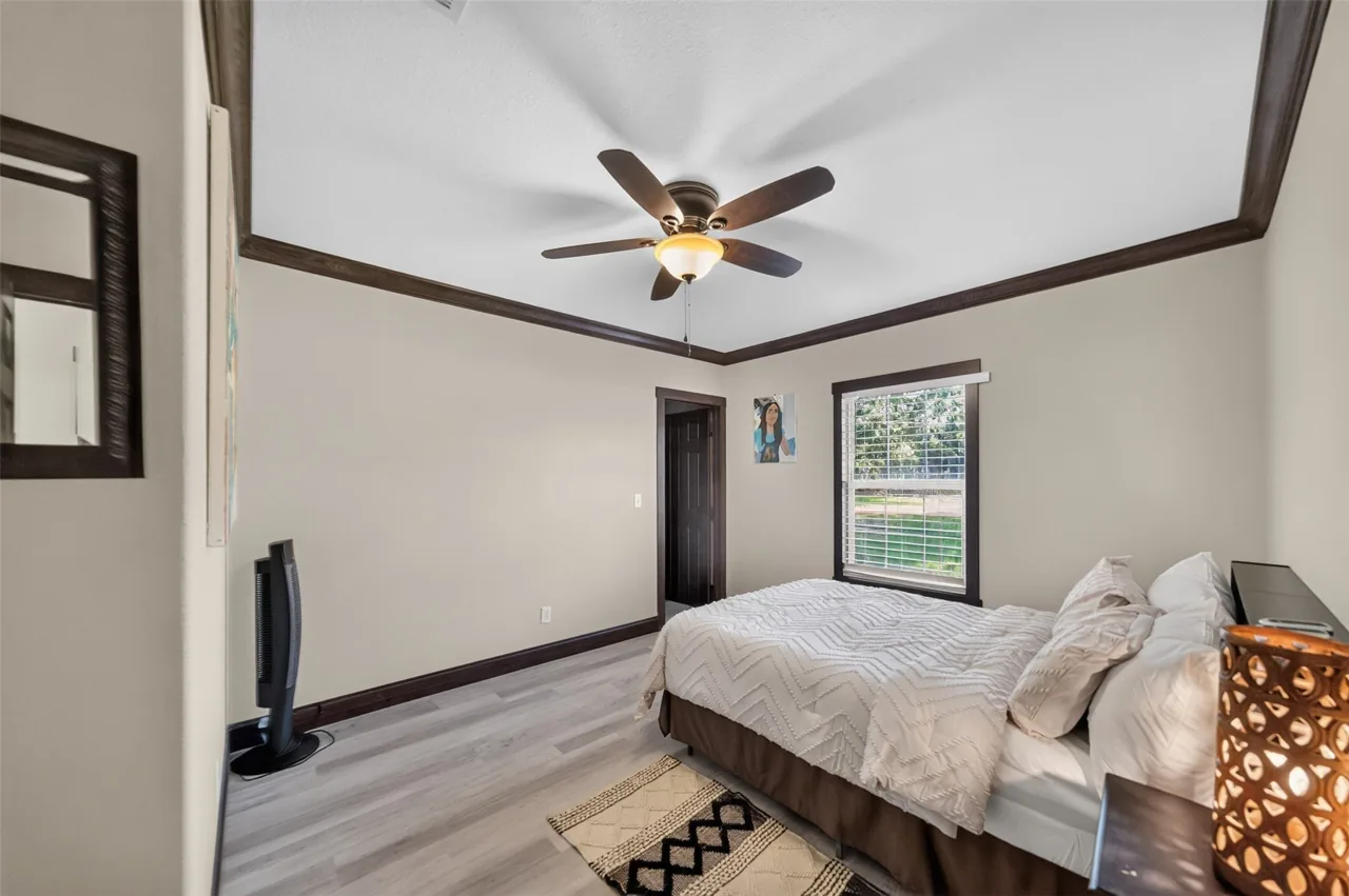 Guest bedroom with a ceiling fan and a window beside the bed at 21138 County Road 4202 in Chandler, TX, across from Brown's Landing on Lake Palestine.