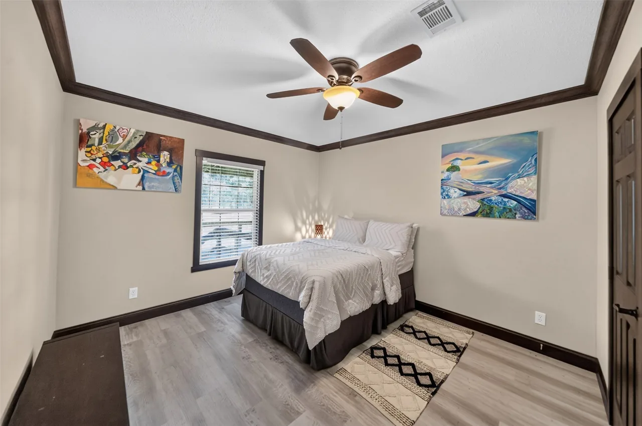 Second guest bedroom with a ceiling fan and a window above the bed at 21138 County Road 4202 in Chandler, TX, across from Brown's Landing on Lake Palestine.