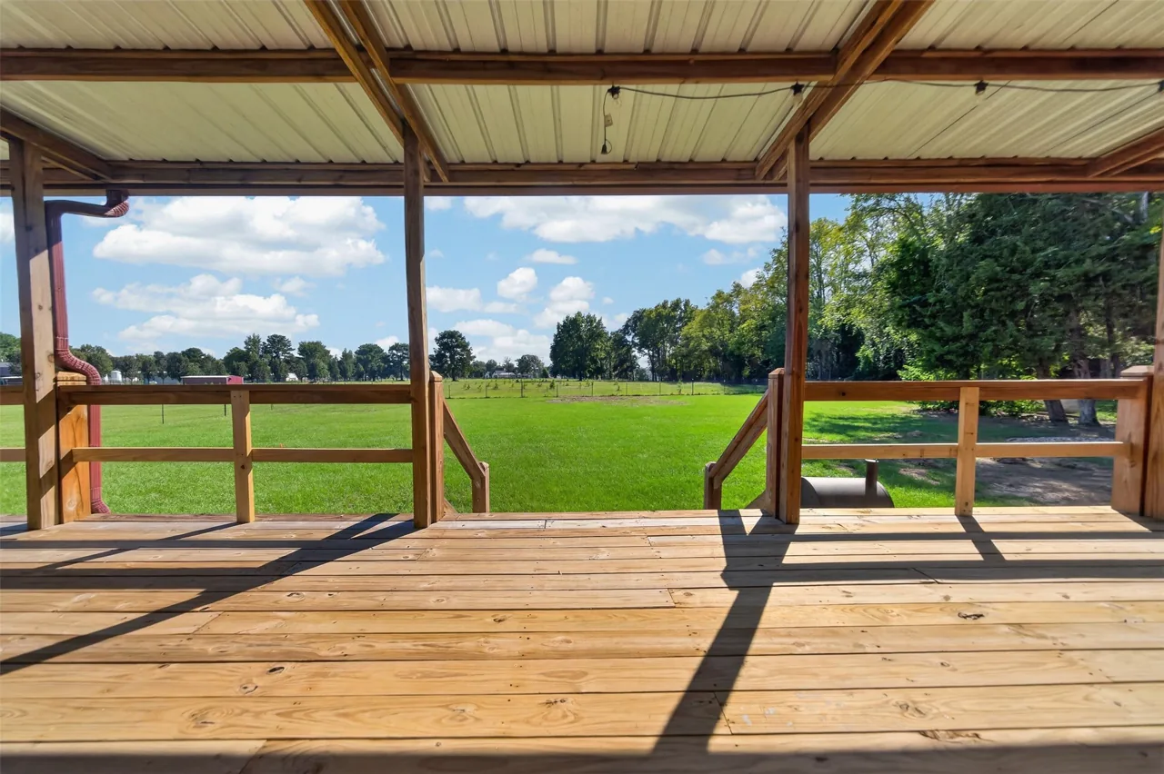 Covered rear deck looking out over the fenced yard at 21138 County Road 4202 in Chandler, TX, across from Brown's Landing on Lake Palestine.